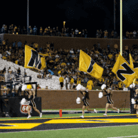 Missouri Football cheer team runs on field