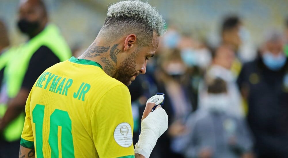 Neymar of Brazil Looks at Medal