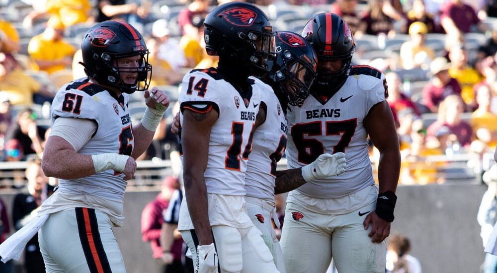 Oregon State Football players celebrate after play