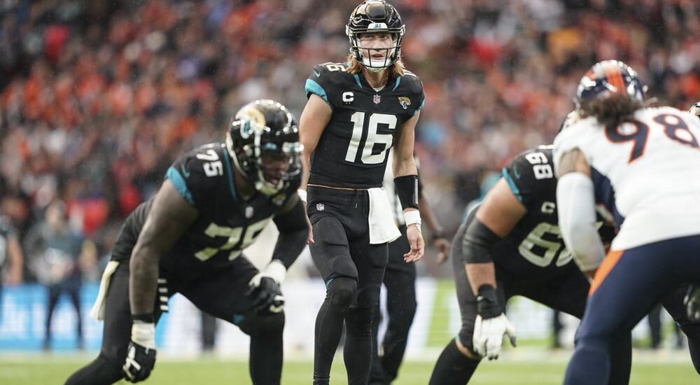 Trevor Lawrence of Jaguars attempts to pass NFL football