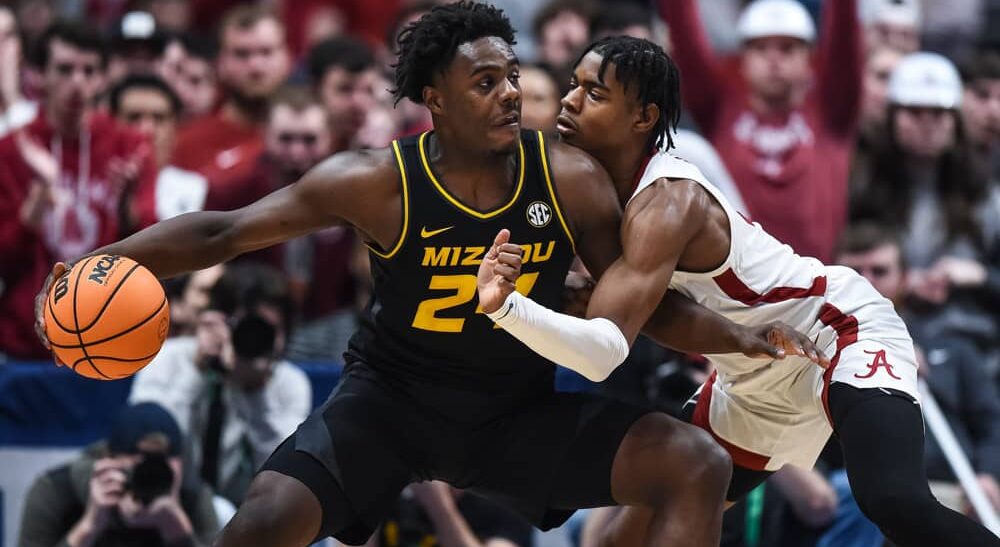 Missouri player dribbles ball in paint