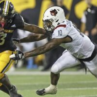 Frank Gore Jr. of Southern Miss runs past defender