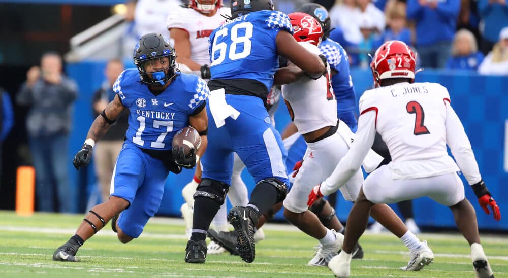 Kentucky football running back carries football