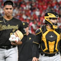 Johan Oviedo of Pirates walks with catcher