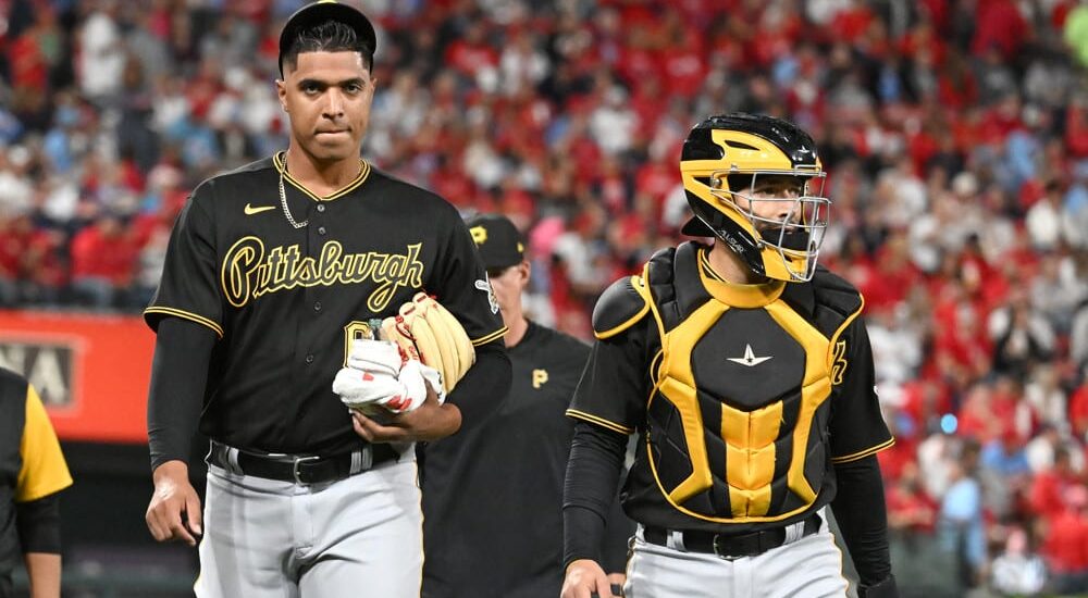 Johan Oviedo of Pirates walks with catcher