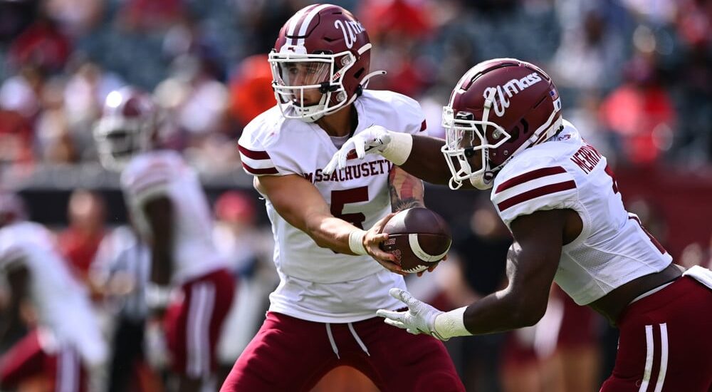 UMass football QB hands ball off to RB