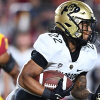 Colorado Football player carries ball