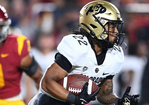 Colorado Football player carries ball