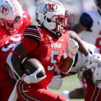 Utah Football player runs with football on offense