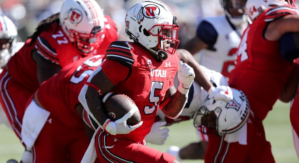 Utah Football player runs with football on offense