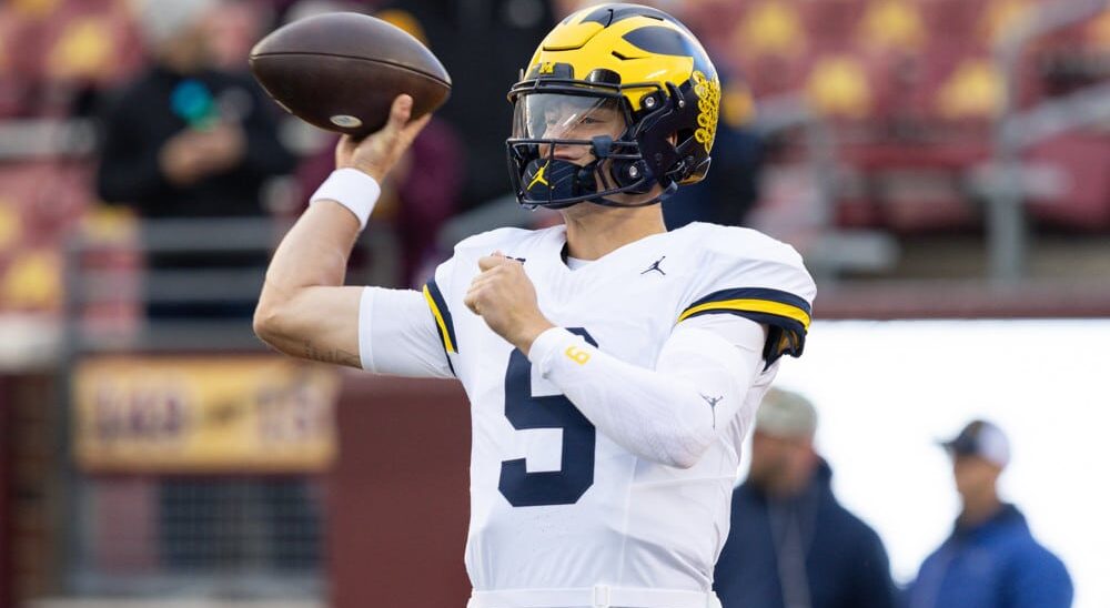 J.J. McCarthy attempts pass in college football